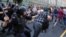 Police chase protesters during a rally against planned increases to the nationwide pension age in Moscow on September 9.