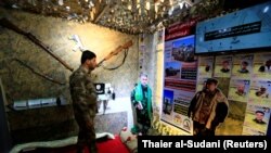 IRAQ -- A member of Hashid Shaabi looks at the Popular Mobilisation Forces (PMF) section of the Baghdad International Fair in Baghdad, November 10, 2018