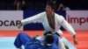 Georgia's Luka Maisuradze (in white) celebrates winning the bronze medal in his fight against Iran's Saeid Mollaei in the men's under 81kg category during the 2019 Judo World Championships.