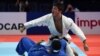 Georgia's Luka Maisuradze (in white) celebrates winning the bronze medal in his fight against Iran's Saeid Mollaei in the men's under 81kg category during the 2019 Judo World Championships.