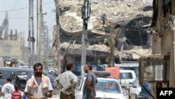 A street lined with collapsed and crumbling buildings in the Shi'ite stronghold of Sadr City in Baghdad.