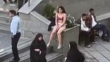 This image grab from a UGC video posted on November 2, 2024, and widely shared on social media shows a female student in her underwear outside Tehran's Islamic Azad University.