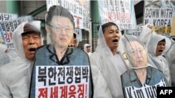 Conservative activists shout slogans at a rally supporting UN sanctions on North Kore in Seoul.