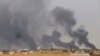 Smoke rises above the Baiji area as Iraqi pro-government forces take part in an operation to retake it from Islamic State militants. 