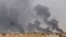 Smoke rises above the Baiji area as Iraqi pro-government forces take part in an operation to retake it from Islamic State militants. 