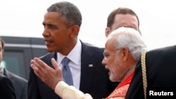 U.S. President Barack Obama (left) talks with India's Prime Minister Narendra Modi upon arriving in New Delhi on January 25.