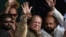 Ousted Pakistani Prime Minister Nawaz Sharif (C) waves to supporters during a rally in Gujrat city in the eastern Punjab province on August 11.