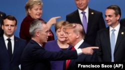 U.K. -- NATO Secretary-General Jens Stoltenberg, front left, speaks with U.S. President Donald Trump, front right, after a group photo at a NATO leaders meeting at The Grove hotel and resort in Watford, Hertfordshire, December 4, 2019