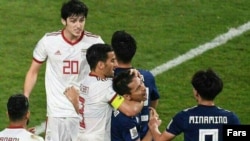 Iranian striker, Ehsan Haj safi, clashes with Japan football player, January 28, 2019.