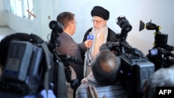 This handout photo provided by the office of Iran's supreme leader, Ayatollah Ali Khamenei, shows him talking to the state television reporters after being discharged from a hospital in Tehran on September 15, 2014.