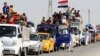 Displaced people riding in trucks and cars head back to their homes in Hawija, on the outskirts of Kirkuk, on October 18.