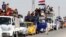 Displaced people riding in trucks and cars head back to their homes in Hawija, on the outskirts of Kirkuk, on October 18.