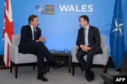 Дейвід Камерон, прем’єр-міністр Великої Британії та Андерс Фоґ Расмуссен, генсек НАТО