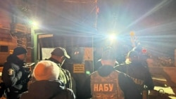 Officers of Ukraine's National Anti-Corruption Bureau (NABU) pass through a checkpoint in the government quarter in Kyiv on November 28, 2025.
