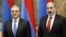 Armenian Prime Minister Nikol Pashinian (right) and then-Foreign Minister Zohrab Mnatsakanian attend an event in Yerevan in March 2019.