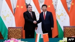 Chinese President Xi Jinping (right) shakes hands with Tajik President Emomali Rahmon in Beijing in September 2015.