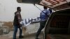 Rescue workers move one of two bodies of a couple who was killed by family members outside the hospital morgue in Karachi on November 27.