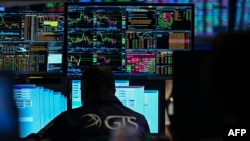 A trader keeps tabs on prices amid renewed optimism about a negotiated end to the Middle East conflict.
