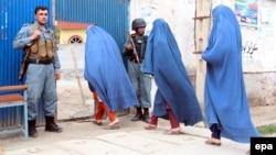 Afghan women arrive to cast ballots at a polling station in Jalalabad, Afghanistan, on April 5.