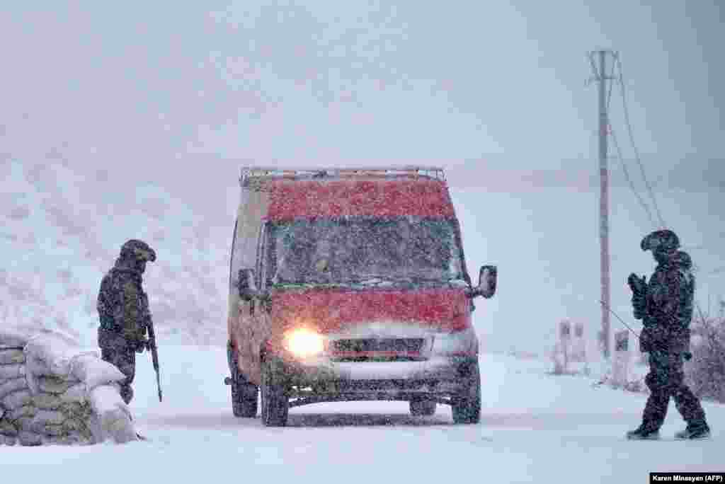 Russian peacekeepers man a checkpoint on the outskirts of Stepanakert on November 29. After six weeks of fighting between ethnic Armenian forces and Azerbaijan&#39;s military, a Moscow-brokered truce was signed on November 9 that brought some 2,000 Russian soldiers to Nagorno-Karabakh.