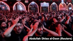 Shi'ite Muslim pilgrims during last year's Arbaeen outside the Imam Al-Hussein shrine in Karbala.