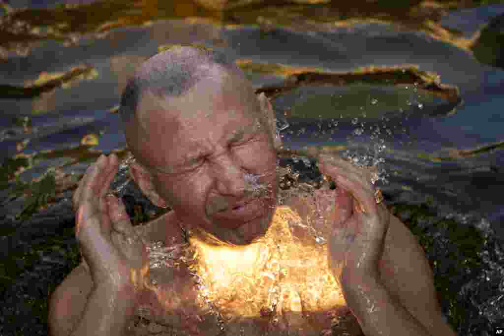 A man plunges in icy water celebrating the Orthodox Epiphany in Moscow on January 19.