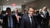 French President Emmanuel Macron, flanked by his advisors and security agents walk from one meeting to another at the United Nations headquarter on September 23, 2019, in New York
