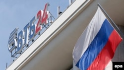 A sign showing VTB24 bank's logo is seen above the bank's headquarters in Moscow, Russia.