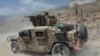 An Afghan soldiers sits in a humvee during an offensive to retake Tora Bora in Pachir wa Agam district in Nangarhar Province on June 20.