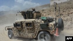 An Afghan soldiers sits in a humvee during an offensive to retake Tora Bora in Pachir wa Agam district in Nangarhar Province on June 20.