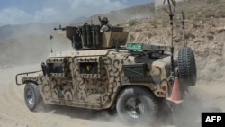 Afghanistan -- An Afghan security personnel sits in a humvee during the ongoing offensive to retake Tora Bora in Pachir Aw Agam district, in Nangarhar province, June 20, 2017