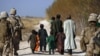 U.S. Marines escort farmers fleeing their land as Marines battle Taliban in Trikh Nawar, near Marjah.