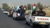 A military convoy drives towards Kirkuk, to reinforce Kurdish troops in Kirkuk on June 24.