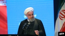 A handout picture made provided by president office shows, Iranian president Hassan Rouhani speaks during the insurance conference in the capital of Tehran on December 4 2019. (Photo by HO / President office / AFP))