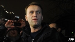 Aleksei Navalny speaks to journalists and supporters outside a police station in Moscow in December 2011.