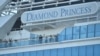 Passengers are seen on the deck of the Diamond Princess cruise ship, with around 3,600 people quarantined onboard due to fears of the new coronavirus, at the Daikaku Pier Cruise Terminal in Yokohama port on February 13, 2020. - At least 218 people on boar