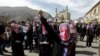 IFILE: Afghan protestor wear masks during a protest to condemn the killing of 27-year-old woman, Farkhunda, who was lynched after a healer allegedly incited a mob in Kabul in 2015.