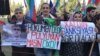 Opposition activists with signs at Baku demonstration