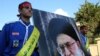 Lebanese boys hold a portrait of leader of the Islamic Republic of Iran, Ayatollah Ali Khamenei during the funeral procession of member of Hezbollah.