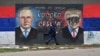 A woman walks past a mural depicting Russian President Vladimir Putin and U.S. President Donald Trump in Belgrade.