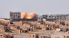 Smoke rises from buildings in the area of Bughayliyah, on the northern outskirts of Deir al-Zor on September 13.