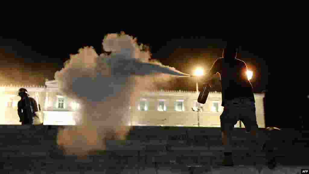 Demonstrators clash with riot police in Athens on April 4, after an elderly man killed himself to protest austerity measures. (AFP/Aris Messinis)