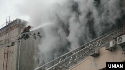 Firefighters battle the deadly blaze as smoke billows from a jeweler factory in Kharkiv on January 8.