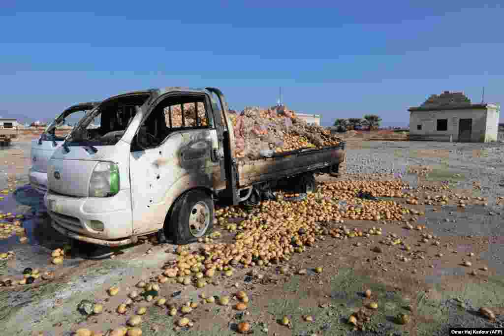 Small trucks loaded with potatoes stand abandoned following air strikes by government forces that hit a vegetable market in the town of Saraqeb in Syria&#39;s northwestern province of Idlib. (AFP/Omar Haj Kadour)