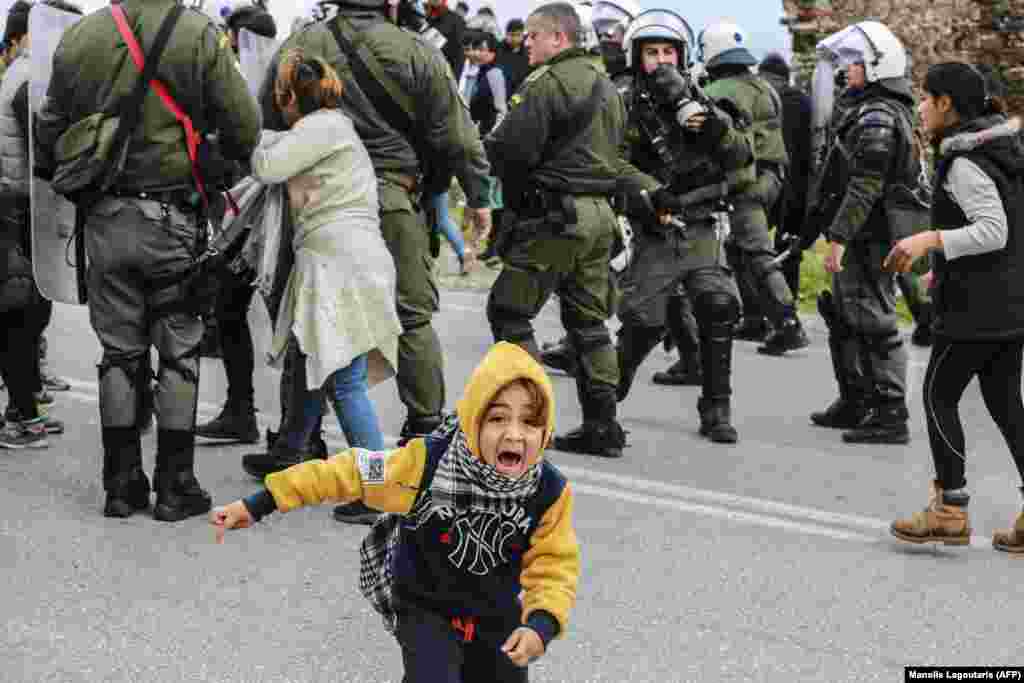 A young migrant reacts during clashes with riot police as refugees and migrants demonstrated against a new law tightening asylum procedures in Greece, outside the Kara Tepe camp on the island of Lesbos. (AFP/Manolis Lagoutaris)