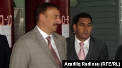 President Ilham Aliyev (left), pictured here with former Economy Minister Farhad Aliyev in 2005. 