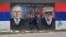 A woman walks past a mural depicting Russian President Vladimir Putin and U.S. President Donald Trump in Belgrade.