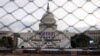 The U.S. Capitol building is seen behind a security fence in Washington on January 19.