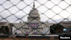 The U.S. Capitol building is seen behind a security fence in Washington on January 19.