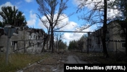 Порожні вулиці Білозерського з будинками, зруйнованими російськими ударами. На табличці одного з будинків написано: вул. Московська